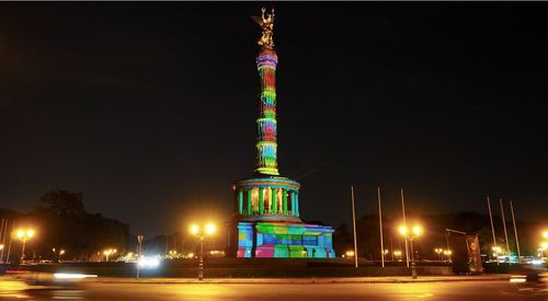 Low angle view of illuminated buildings against sky at night