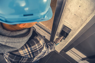 Midsection of man working in factory