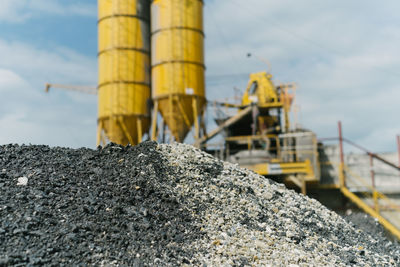 Low angle view of yellow metal structure against sky