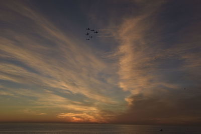 Low angle view of sea against sky during sunset