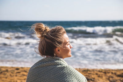 Close-up of woman at sea against sky