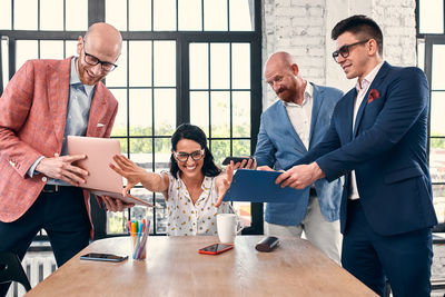 Friends standing on table at home