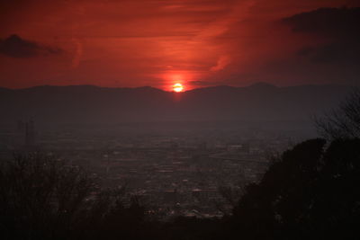 Silhouette of mountain against sky at sunset