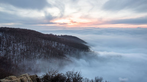 Scenic view of waterfall against sky during sunset