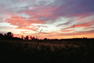 Scenic view of silhouette field against sky during sunset