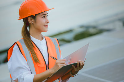 Portrait of young man working at construction site