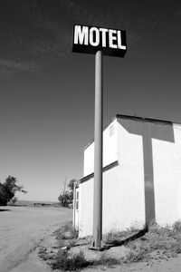 Low angle view of road sign against clear sky