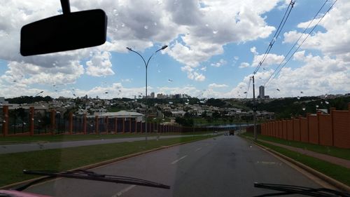 Empty road against cloudy sky