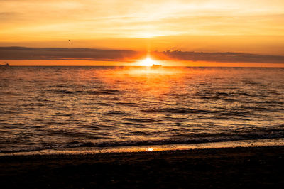 Scenic view of sea against romantic sky at sunset