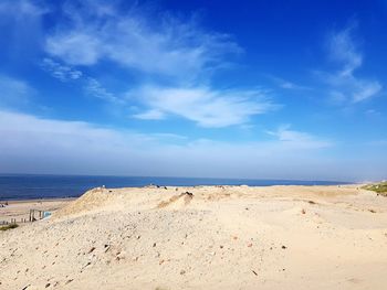 Scenic view of beach against blue sky