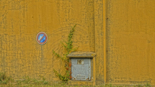 Closed door of yellow house