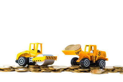 Close-up of yellow toy car over white background