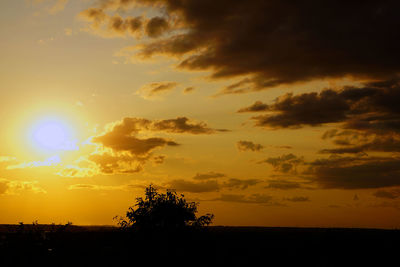 Scenic view of silhouette landscape against orange sky