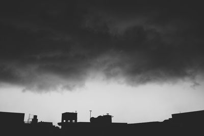 Low angle view of building against cloudy sky