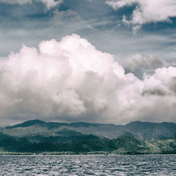 Scenic view of sea and mountains against sky