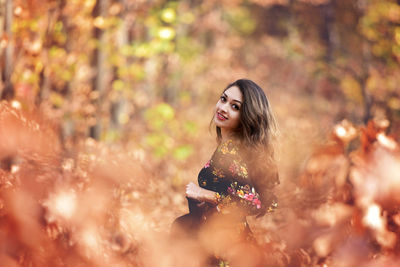 Portrait of young woman in park