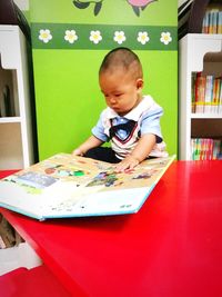 Boy sitting on book