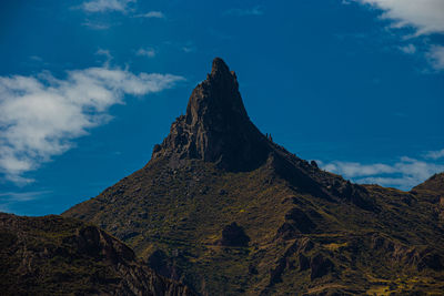 Low angle view of rock formations against sky