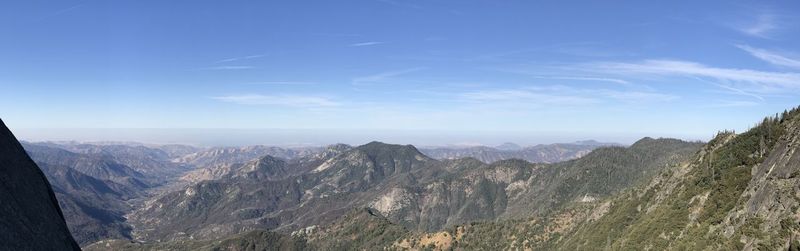 Scenic view of mountains against blue sky