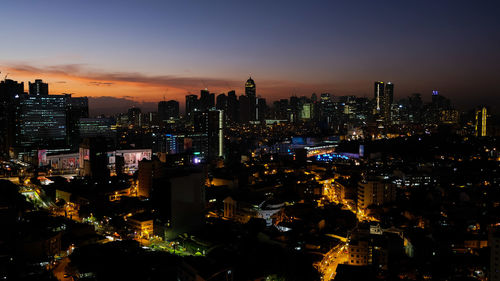 High angle view of illuminated buildings against sky at night