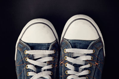 Close-up of canvas shoes over black background