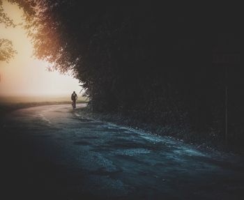 Silhouette man on beach against sky at night