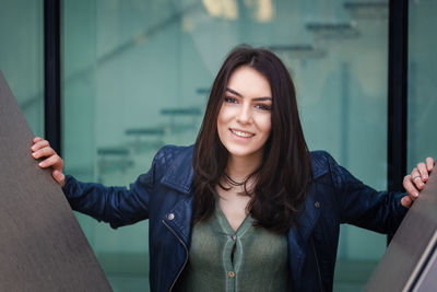 Portrait of hipster happy teenage girl smiling at camera outdoors