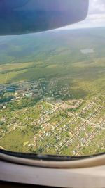 Aerial view of landscape seen through airplane window