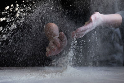 Woman baker with flour in her hands