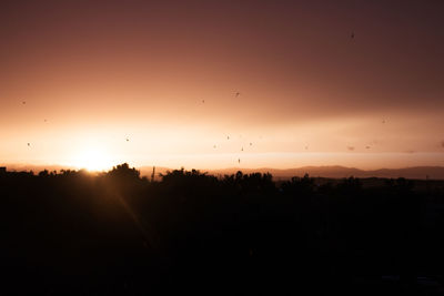 Scenic view of silhouette landscape against sky during sunset