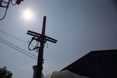 Low angle view of sun shining through clouds