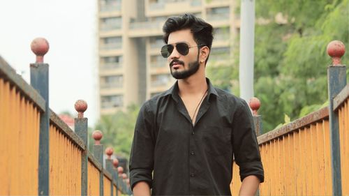 Young man wearing sunglasses standing outdoors