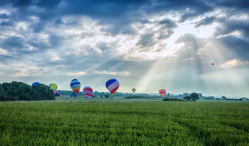 Scenic view of grassy field against cloudy sky