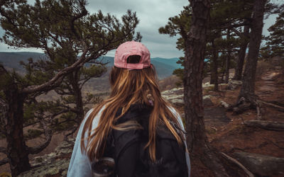 Portrait of woman standing by tree