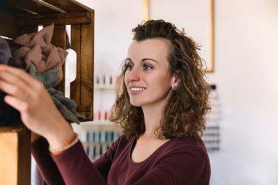 Side profile of a female fashion designer thoughtfully touching