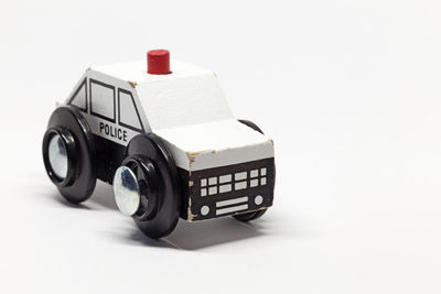 Close-up of toy car on table against white background