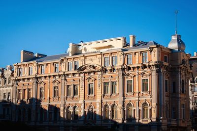 Low angle view of buildings against clear blue sky