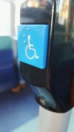 Close-up of information sign against blue sky