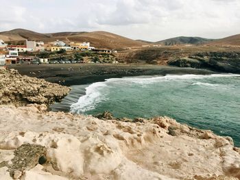 Scenic view of sea and mountains against sky