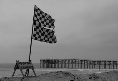 Lifeguard hut on beach against sky