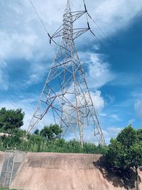 Low angle view of electricity pylon against sky