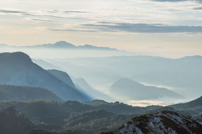 Scenic view of snowcapped mountains against sky during sunset