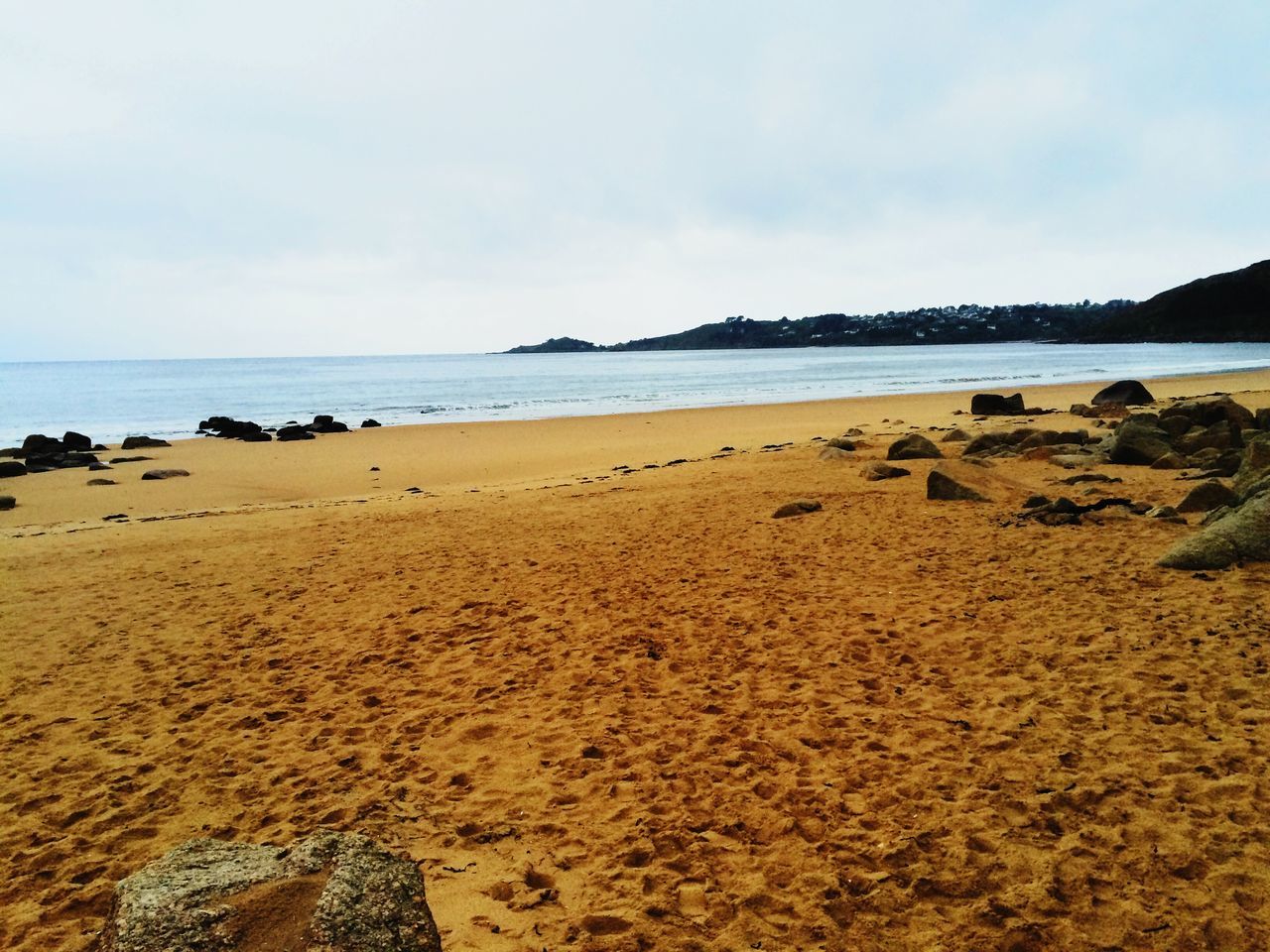 beach, sea, water, sand, shore, tranquil scene, sky, tranquility, scenics, beauty in nature, horizon over water, nature, coastline, idyllic, remote, outdoors, day, blue, rock - object, cloud - sky