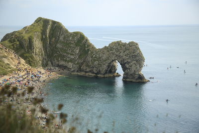 Scenic view of rocks in sea against sky