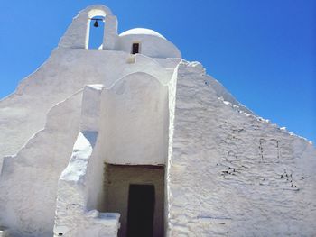 Low angle view of built structure against clear blue sky