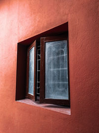 Low angle view of window on wall of building