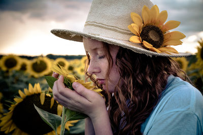 Portrait of woman holding sunflower