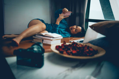 Boy lying on table at home