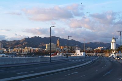 Road by city against sky