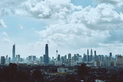 Aerial view of modern buildings in city against sky
